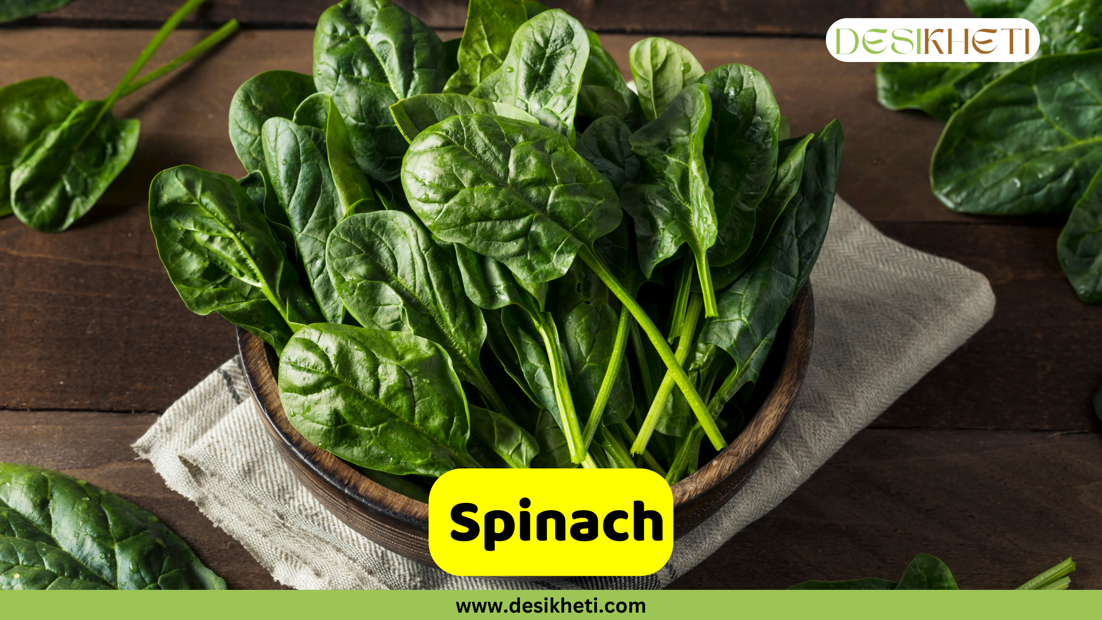 
"Spinach" poster showing a bowl filled with fresh spinach leaves on a wooden surface with a beige cloth napkin. The logo "DESIKHETI" is in the top right corner. The website address "www.desikheti.com" is at the bottom center.